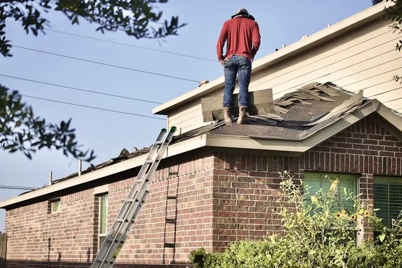 Professional roofer working on a residential roof in Oronoko